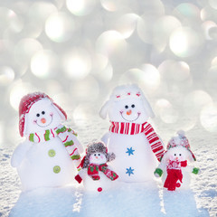Family snowman on snow