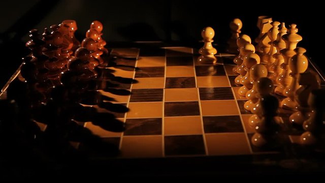Static shot of a person playing chess isolated on black.Dramatic Lighting