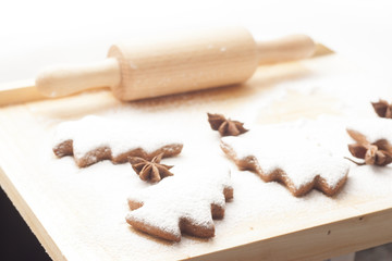Fototapeta na wymiar christmas gingerbread cookies baking process , dough and rolling pin,shallow depth of field.
