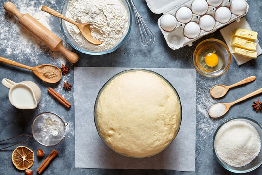 Dough preparation recipe bread, pizza or pie making ingridients, food flat lay on kitchen table background. Working with butter, milk, yeast, flour, eggs, sugar pastry or bakery cooking.