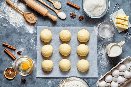 Buns dough homemade preparing recipe, ingridients food flat lay on kitchen table background. Working with butter, milk, yeast, flour, eggs, sugar pastry or bakery cooking.