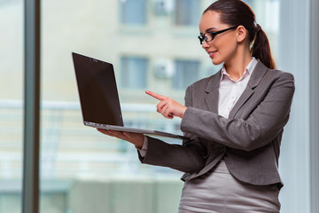 Businesswoman with laptop in business concept