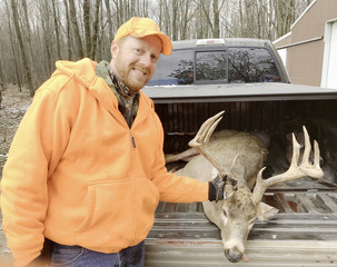 Fototapeta premium Deer hunter with a trophy whitetail buck