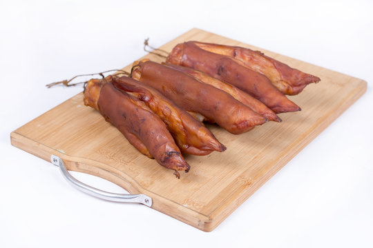 Smoked pork hooves on the wooden board