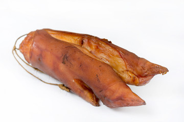 Smoked pork hooves over white background