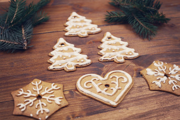 Christmas tree decoration made from gingerbread cookies on wooden table. New year background
