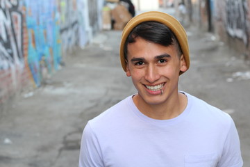Young male with piercing and beanie outdoors 