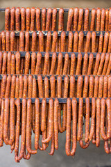 Hanging domestic homemade smoked red sausages