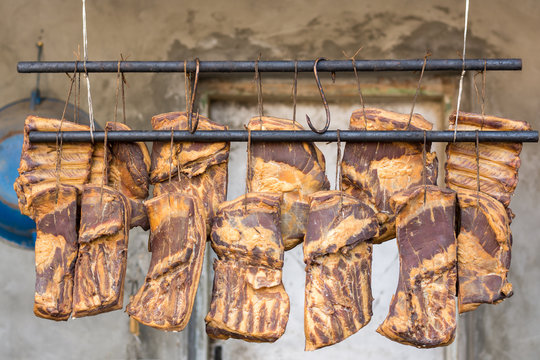 Hanging smoked domestic pork bacon