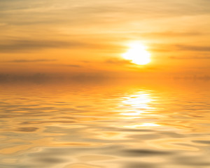 Sunset over calm ocean or sea