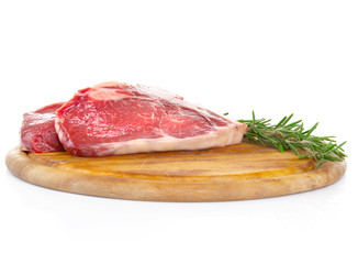 Raw steak with spices on cutting board, isolated on white