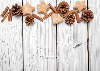 Christmas pine cone decoration on white wooden board