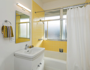 Beautiful Bathroom in white /yellow with shower curtain.