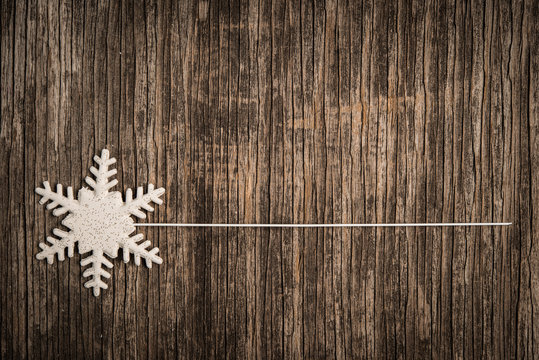 Snowflake and line for text on rustic wood