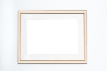 Blank picture frame on white wall background