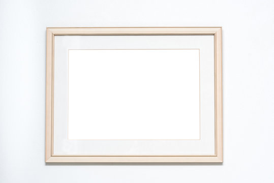 Blank picture frame on white wall background