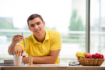 Young man drawing pictures in studio