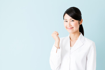 portrait of young asian nurse isolated on blue background