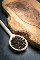 black pepper on rustic wooden table with copy space