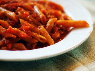 Italian food - Penne al'arrabbiata (Angry Pens), a classic italian pasta recipe with spicy tomato sauce, red hot peppers and parsley.