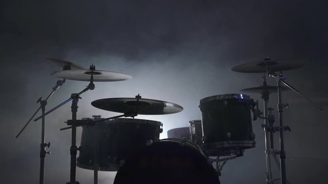View of modern drum kit in smoky studio