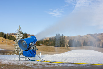 Cannon fires snow on the ski slopes