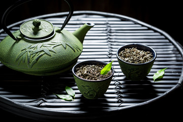 Obraz na płótnie Canvas Enjoy your herbal tea with teapot on black table