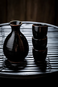 Tasty sake in black ceramics on black table