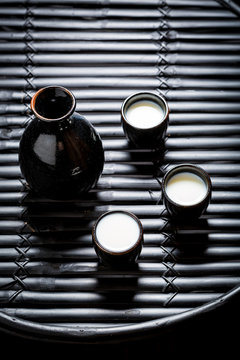 Prepared to drink sake in black ceramics on black table