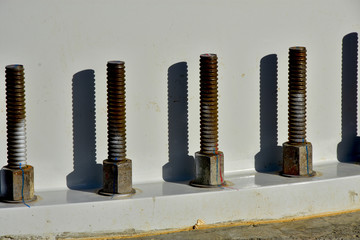 base section of turbine tower, concrete foundation and large bolts.