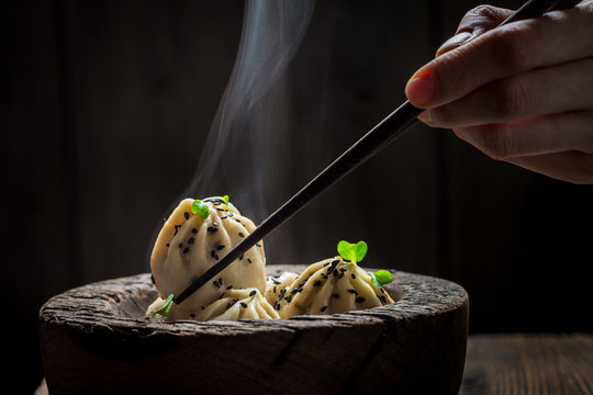 Tasty and hot chinese dumplings in wooden bowl