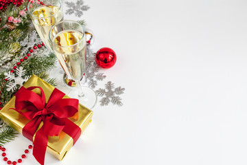 glasses of champagne and Christmas ornaments top view