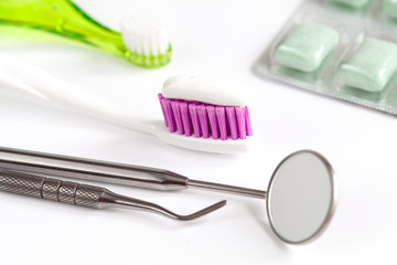 dental care toothbrush with dentist tools on white background