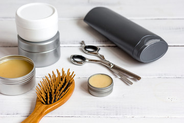 Men's cosmetics for hair care on wooden background