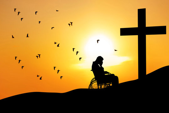 Disabled male with cross in mountain