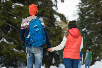 Romantic Couple Snow Forest Outdoor Winter Walk Man And Woman Holding Hands Back Rear View Pine Woods