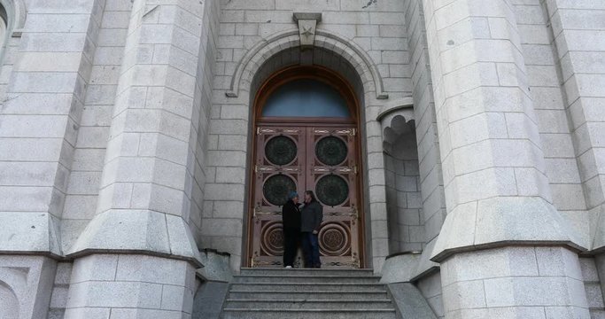 Salt Lake City LDS Temple door husband wife steps towards. The Church of Jesus Christ of Latter-day Saints, LDS or Mormon Church. Christmas holiday season, colorful lights. Headquarters Christian.