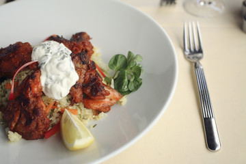 Chicken with sauce and rice and lemon
