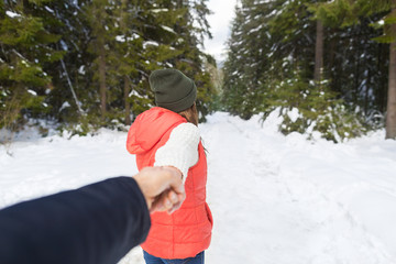 Fototapeta na wymiar Woman Hold Man Hand Romantic Couple Snow Forest Outdoor Winter Walk Pine Woods