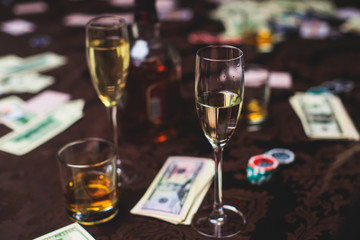 A close-up vibrant image of multicolored casino table and a group of gambling rich wealthy people in the background

