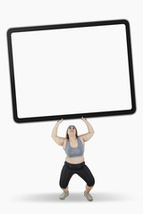 Overweight woman lifts big board