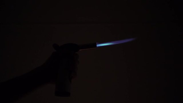 Letting out some gas from the lighter in the dark