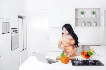 Woman with a laptop in kitchen