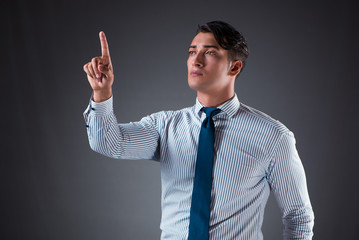 Handsome businessman pressing virtual buttons