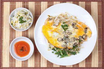 Oyster omelet with herb call Hoi Tod Khai in Thai .