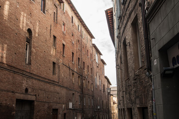 narrow street and old houses in Siena
