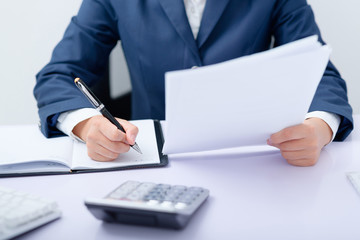 Young business woman working at desk.