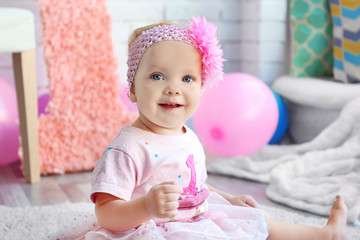 Portrait of one year-old baby girl indoors