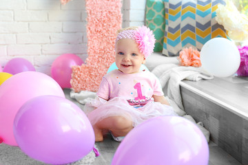 Fototapeta na wymiar Portrait of one year-old baby girl indoors