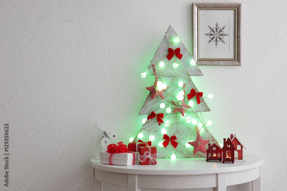 Sticker decorated handmade christmas tree on white table